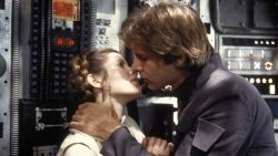 Carrie Fisher and Harrison Ford kiss in a scene from "The Empire Strikes Back."