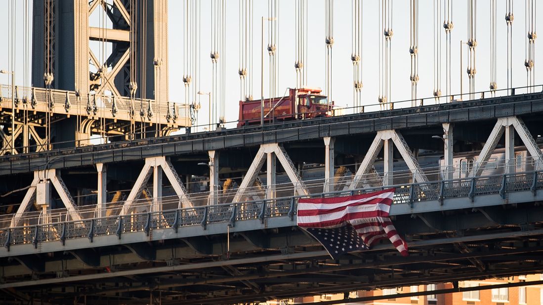 Anti-Trump protesters in New York hung an upside-down American flag from the side of the Manhattan Bridge on November 14.