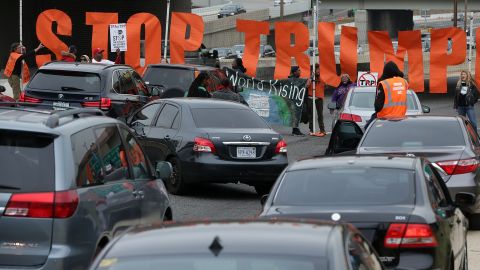 Activists use a banner to block traffic on Interstate 395 during an anti-Trump protest in Washington on Monday, November 14.