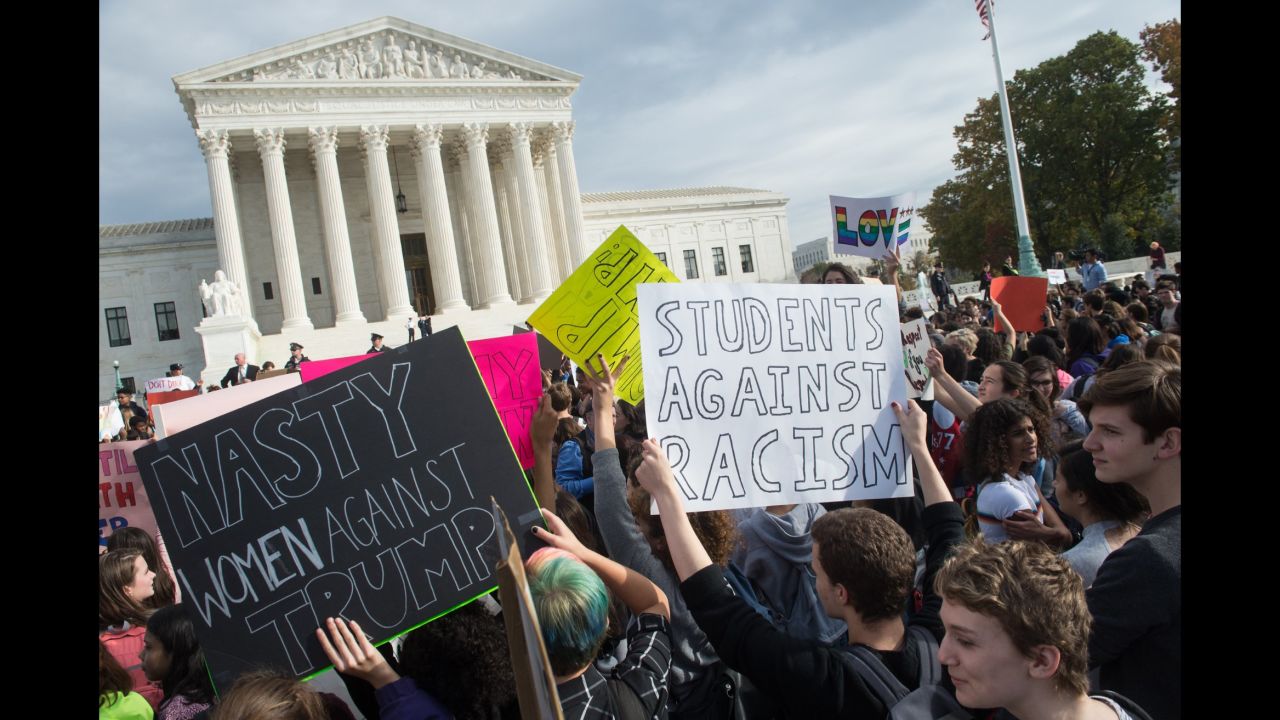 Students hold signs in front of the Supreme Court in Washington during a protest on Tuesday, November 15.