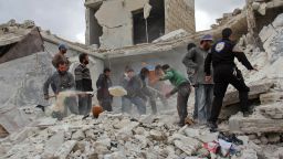 Rescuers and civilians inspect a destroyed building in the Syrian village of Kfar Jales, on the outskirts of Idlib, following air strikes by Syrian and Russian warplanes on November 16, 2016.  
Syrian and Russian warplanes bombed rebel-held areas in Aleppo and Idlib province overnight, a monitor said, a day after Moscow announced a fresh offensive against opponents of its Damascus ally.

 / AFP / Omar haj kadour        (Photo credit should read OMAR HAJ KADOUR/AFP/Getty Images)