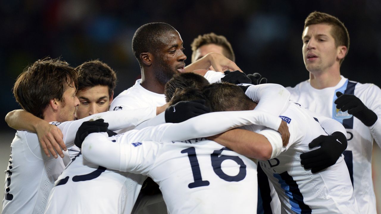 Yaya Toure (center) is surrounded by Manchester City teammates during the October, 2013 UEFA Champions League match at CSKA Moscow, where he endured racist chancts from the stands. 