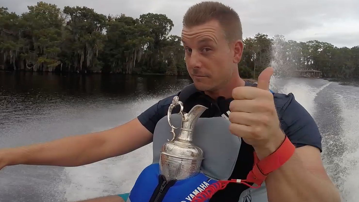 Open champion Henrik Stenson jet skiing in Florida with golf's famous Claret Jug.