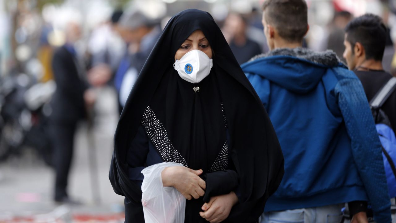 An Iranian woman wears mask as she walk in a street in Tehran on November 16, 2016.