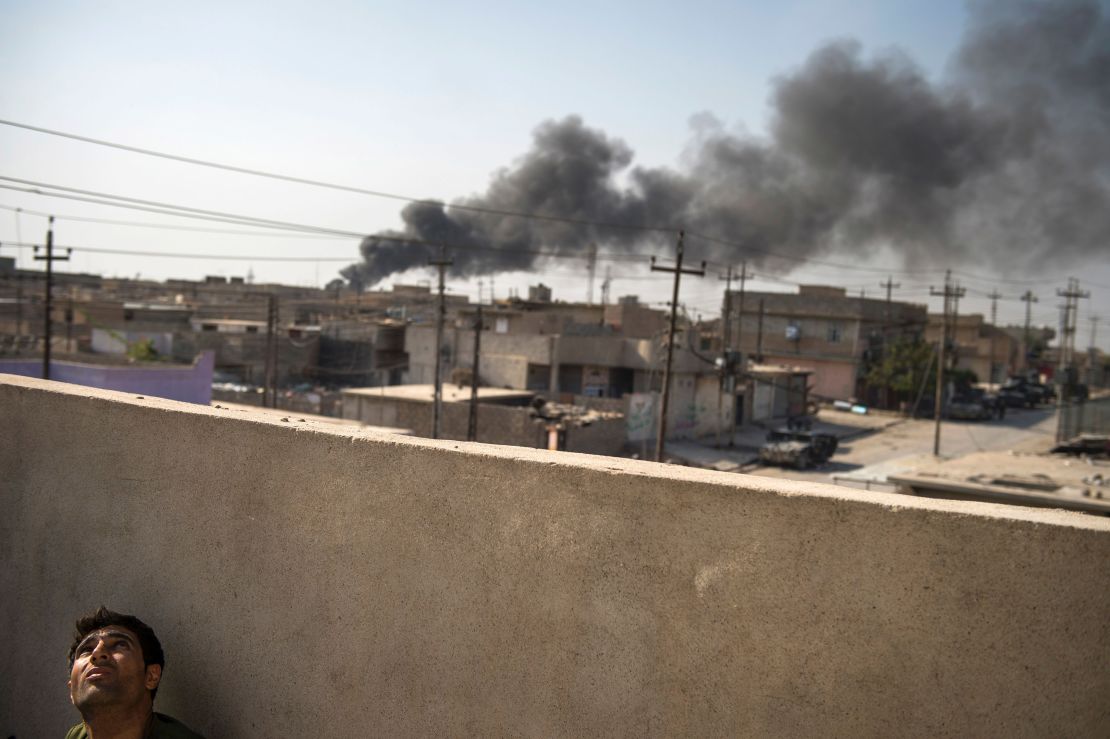 A drone operator from the Iraqi special forces watches his aircraft in Mosul's Karkukli neighborhood.