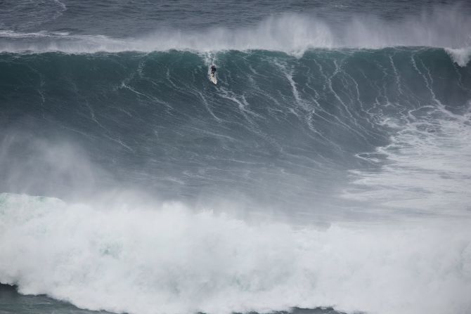 He admits there are dangers to big wave surfing and says he feels fear every time it comes to tackle the monstrous swells -- such as this one at Praia do Norte in Nazaré, Portugal.