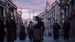 TOPSHOT - This picture taken on September 11, 2016 shows pilgrims walking and praying near the Jokhang Temple in the regional capital Lhasa, in China's Tibet Autonomous Region. / AFP / JOHANNES EISELE        (Photo credit should read JOHANNES EISELE/AFP/Getty Images)