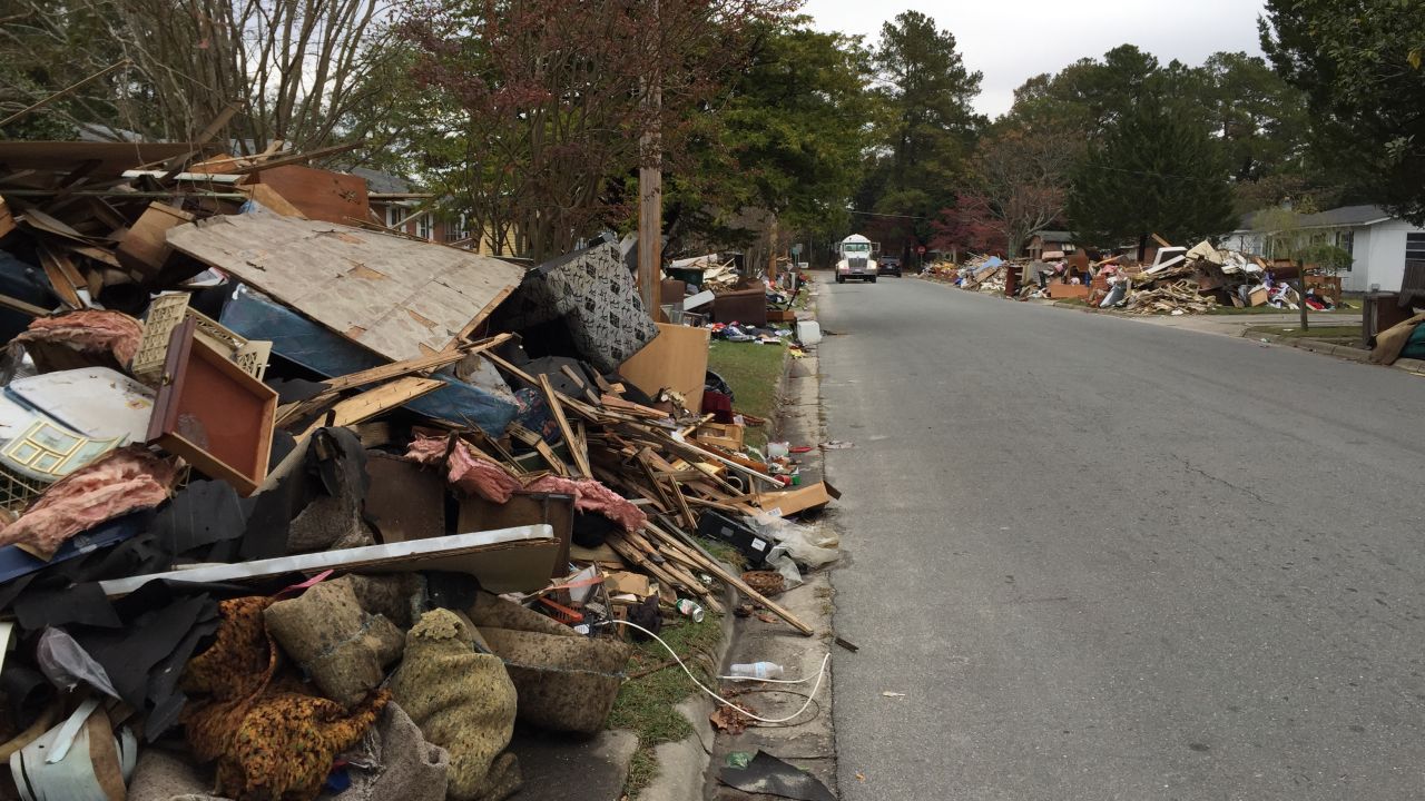 Weeks after Hurricane Matthew, debris piles in yards make it seem like the storm just hit Lumberton.