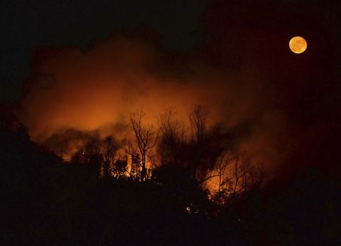 A wildfire burns as it approaches Bat Cave, North Carolina, on November 15.