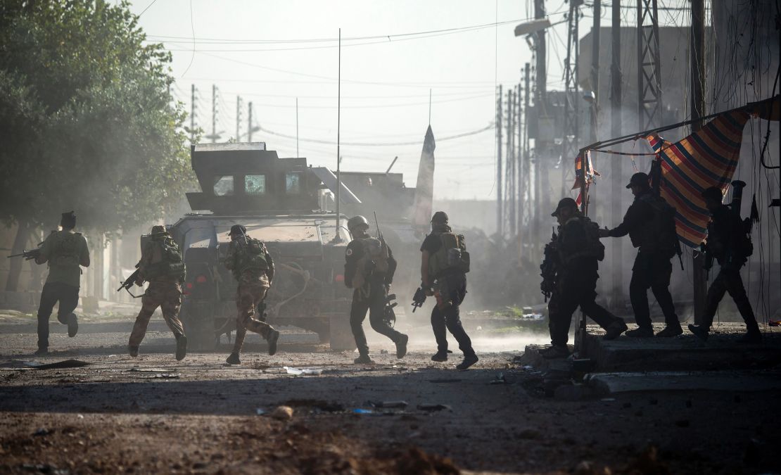 Iraqi soldiers come under fire from ISIS fighters as they try to push forward in Karkukli, Mosul.