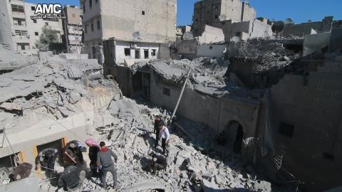 Teams work through the rubble of one of Thursday's airstrikes on Aleppo.