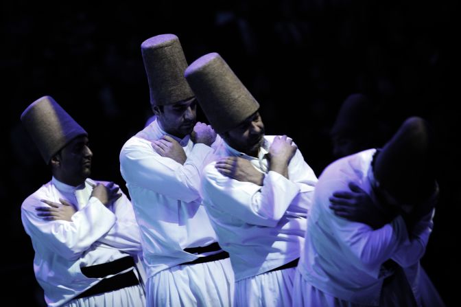 Whirling dervishes salute a "Postisin", leader of the troupe, at the end of a ceremony marking the anniversary of the death of Rumi.