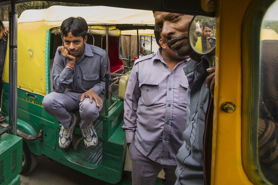 Sarvesh on his auto rickshaw with other drivers.