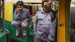 Sarvesh sitting on his auto rickshaw.
