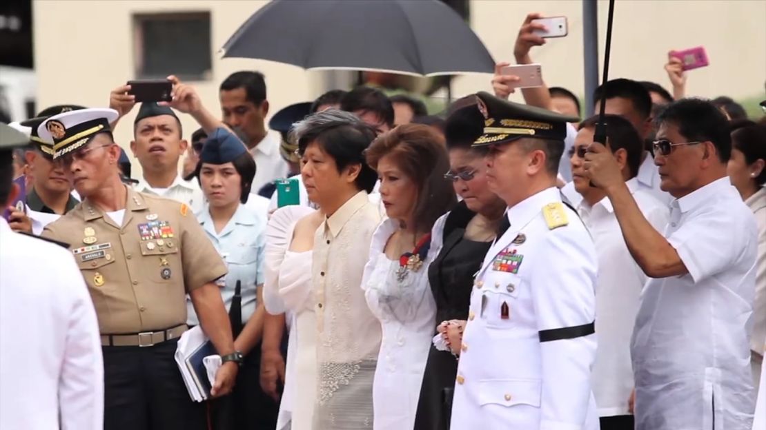 Marcos family members, including his children, Ferdinand "Bongbong" Marcos and Imee Marcos, and his widow Imelda Marcos (in black) attend the ceremony.