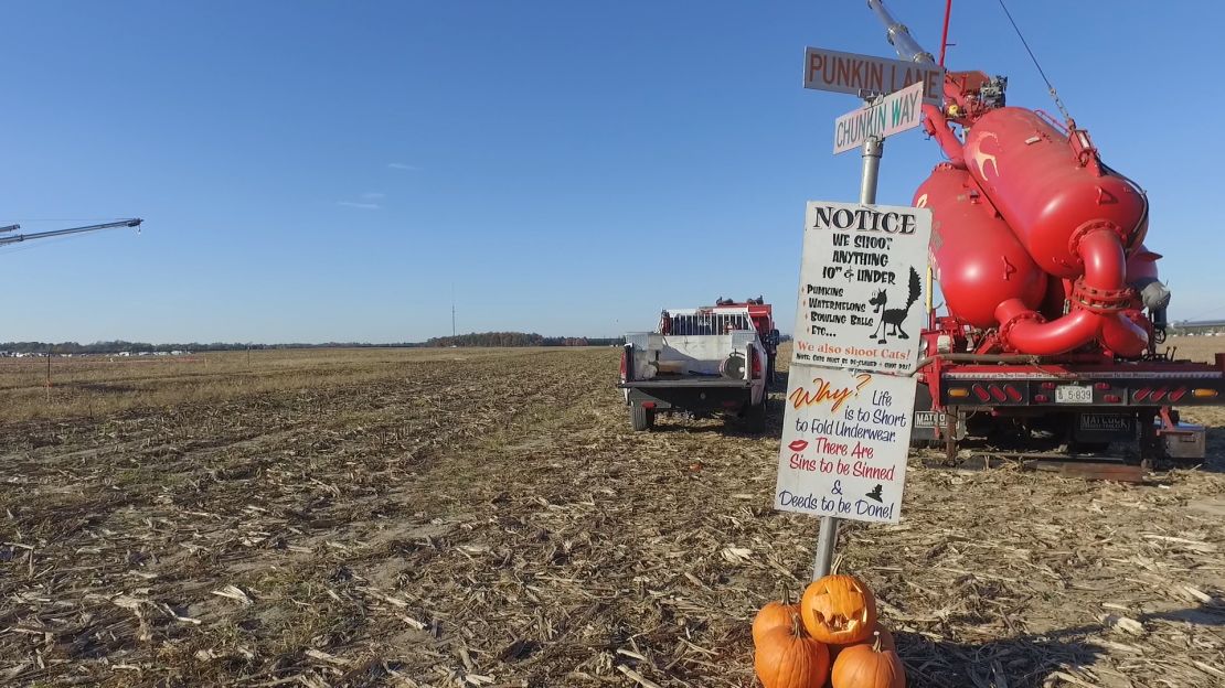 One of the air cannons that fires pumpkins is adorned with a humorous sign, in the whimsical spirit of Punkin Chunkin.