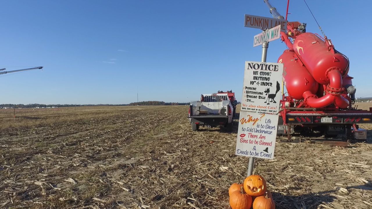 One of the air cannons that fires pumpkins is adorned with a humorous sign, in the whimsical spirit of Punkin Chunkin.