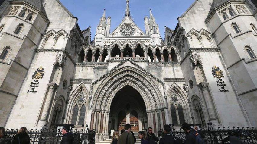 FILE - In this Thursday Nov. 3, 2016 file photo media gather outside the High Court in London. High Court Judge Peter Jackson has granted the final wishes of a 14-year-old girl to be cryogenically preserved, in what he called the first case of its kind in England — and possibly the world. (AP Photo/Tim Ireland, File)
