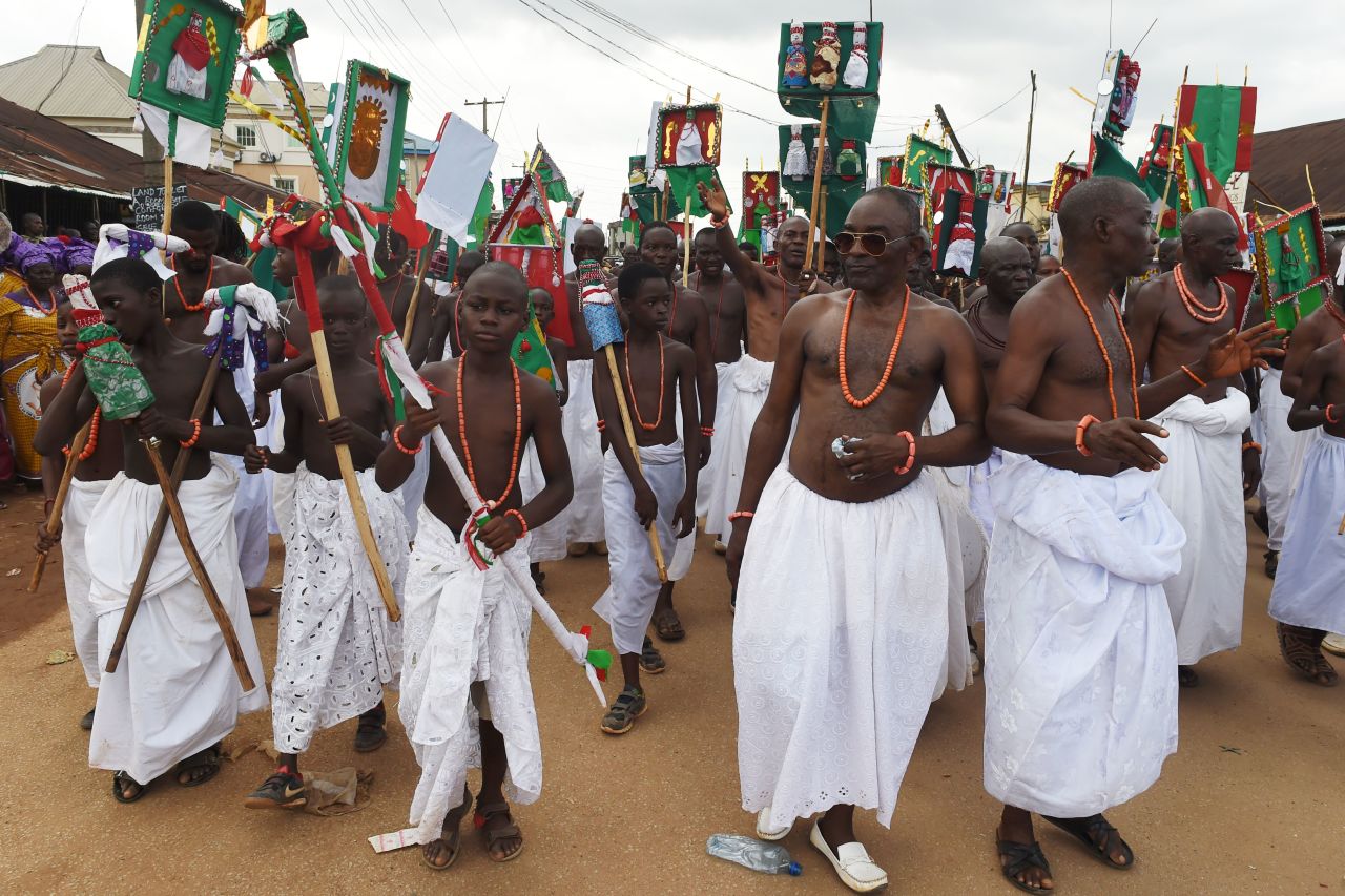 Royalist supporters dance and parade during the coronation ceremony of the new Oba.