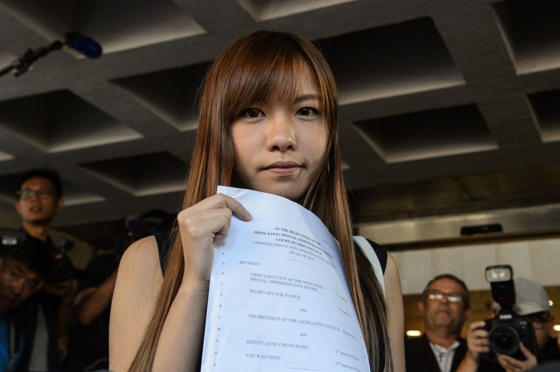 Yau Wai-ching holds a court ruling as she leaves the High Court in Hong Kong on November 15, 2016.