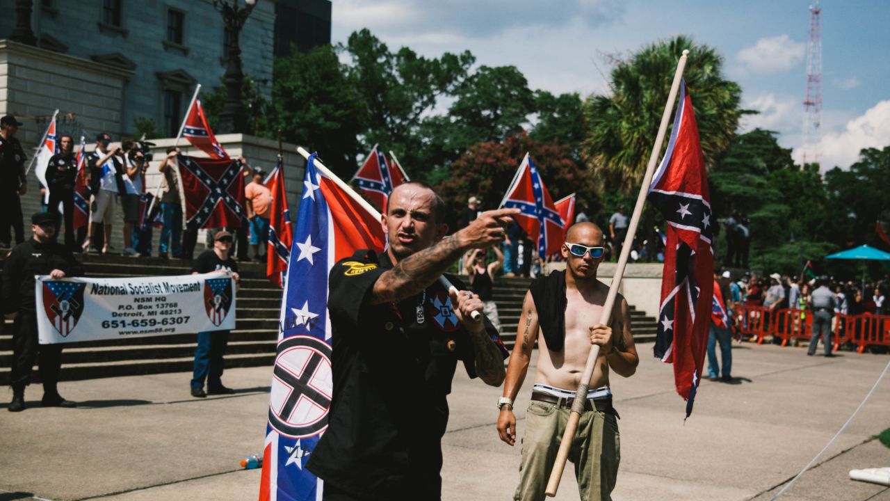 A member of th Ku Klux Klan from Kentucky, left, and a member of the Loyal White Knights a branch of the Ku Klux Klan from Pelham, North Carolina are seen during a Klan rally at the South Carolina State House in protest against the removal of the Confederate Flag from the State House grounds on July, 18, 2015. 