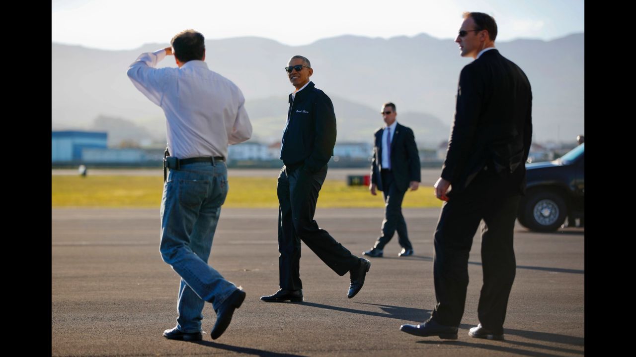 Obama walks across the tarmac during the refueling stop in the Azores.