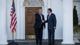 President-elect Donald Trump shakes hands with Mitt Romney after their meeting at Trump International Golf Club, November 19, 2016 in Bedminster Township, New Jersey.