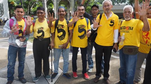 Protesters in yellow T-shirts gather Saturday in Kuala Lumpur to march against Malaysia's government.
