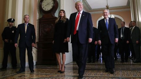 Trump walks with his wife and Senate Majority Leader Mitch McConnell after a meeting at the US Capitol on November 10. 