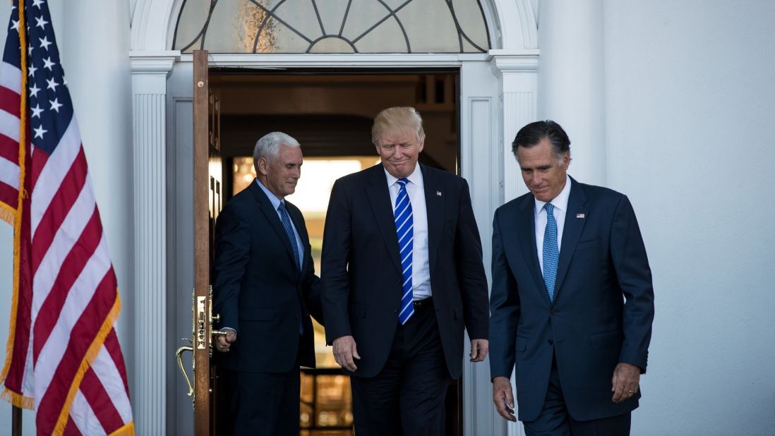 Trump is flanked by Pence and  Romney after a meeting in Bedminster Township, New Jersey, on Saturday, November 19.