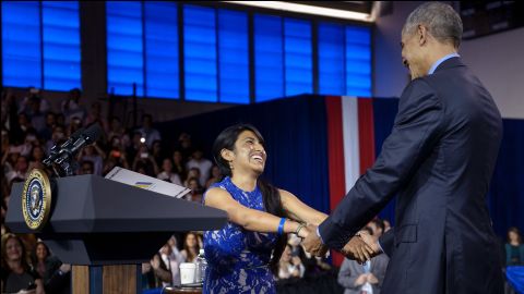 Cyntia Paytan greets Obama after introducing him at the town-hall meeting.