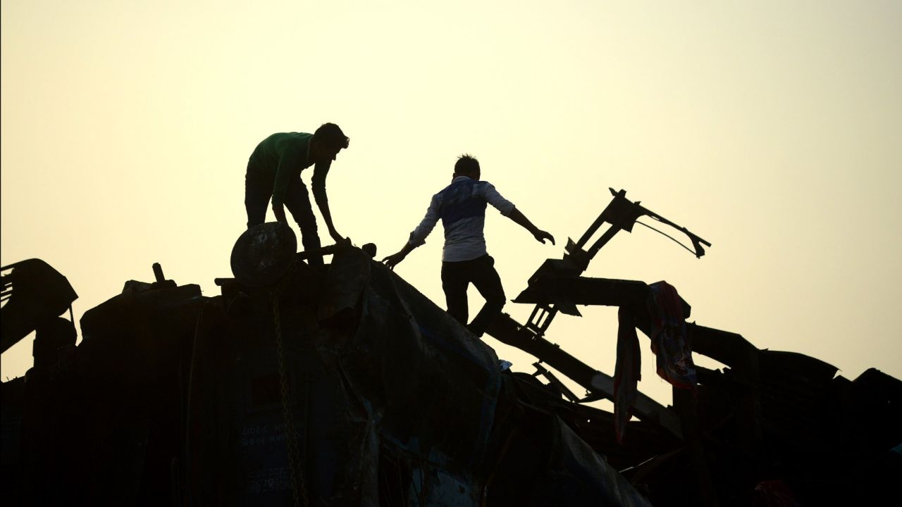 Indian rescue workers search for survivors in the wreckage.