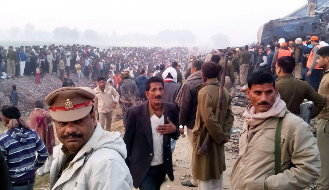 Onlookers and survivors gather next to wreckage of the train that derailed Sunday near Kanpur, India.