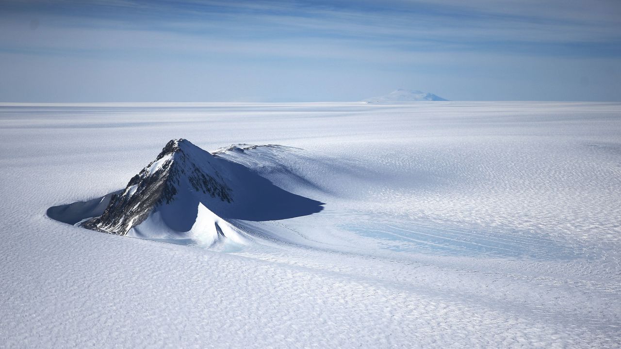 An Antarctic mountain stands in stark relief against the wastes of the West Antarctic Ice Sheet. NASA's Operation Ice Bridge is gauging the rate of decline of ice cover caused by global warming.<br />