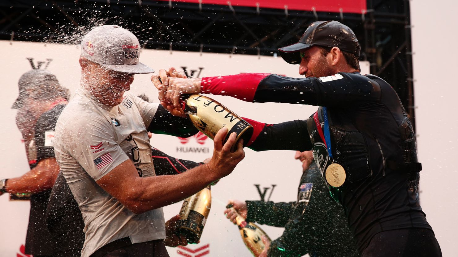 Ben Ainslie celebrates his team's America's Cup World series with and Jimmy Spithill of Oracle Team USA.