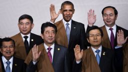(L to R back) Thailand's Deputy Prime Minister Prajin Juntong, US President Barack Obama and Vietnam's President Tran Dai Quang; (L to R front) Indonesia's Vice President Jusuf Kalla, Japan's Prime Minister Shinzo Abe and South Korea's Prime Minister Hwang Kyo-Ahn wave during the traditional "family photo" on the final day of the Asia-Pacific Economic Cooperation (APEC) Summit at the Lima Convention Centre in Lima on November 20, 2016.
