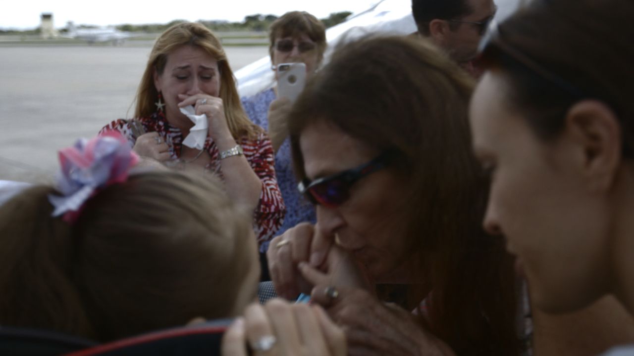 Kim Muszynski weeps as her mother kisses Abby goodbye at Boca Raton Airport in Florida.