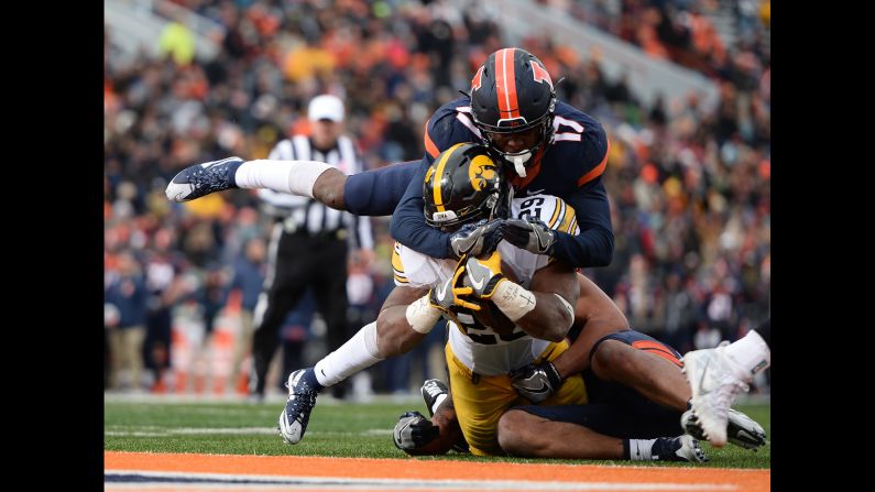 Iowa running back LeShun Daniels Jr. is tackled by Illinois defenders during a college football game in Champaign, Illinois, on Saturday, November 19. Daniels rushed for 159 yards and two touchdowns as Iowa won 28-0.