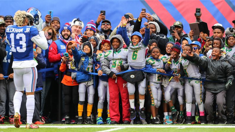 Wide receiver Odell Beckham Jr. takes his helmet off for a youth football team before a New York Giants home game on Sunday, November 20.