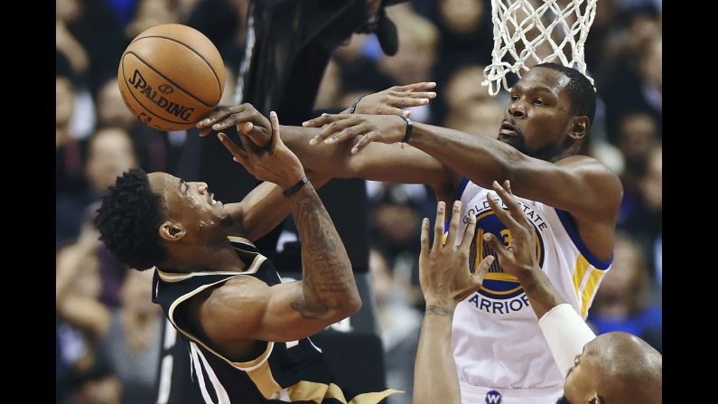 Toronto's DeMar DeRozan is fouled by Golden State's Kevin Durant during an NBA game in Toronto on Wednesday, November 16. DeRozan scored 34 points, becoming the first NBA player since Michael Jordan to score 30 points in the first 11 games of the season. But Durant and the Warriors won 127-121.