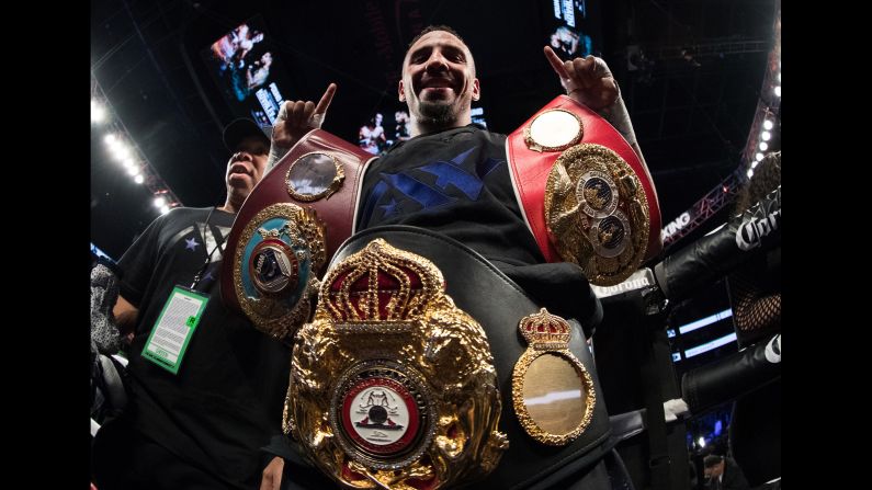 Andre Ward celebrates with three title belts after winning a unanimous decision over Sergey Kovalev on Saturday, November 19. The two light-heavyweights came into the bout undefeated. Ward won narrowly on all three scorecards (114-113).