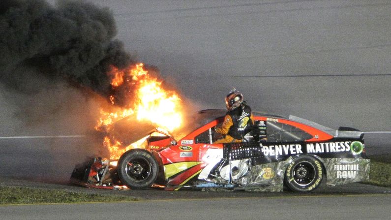 Martin Truex Jr. gets out of his flaming car after crashing in the NASCAR season's final Sprint Cup race on Sunday, November 20.