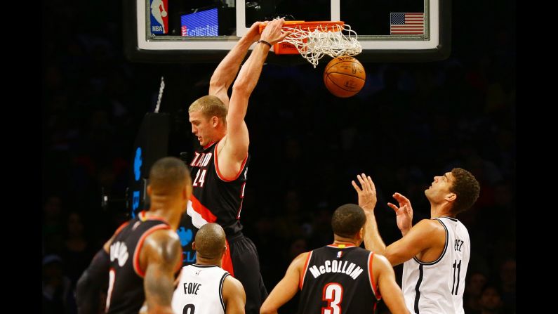 Portland's Mason Plumlee throws down a reverse dunk during an NBA game against Brooklyn on Sunday, November 20.