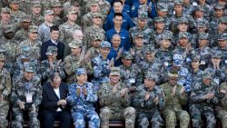U.S. Army Pacific commander Gen. Robert Brown, front row center, and Gen. Liu Xiaowu, front row third right, the commander for Southern Theater Command Army of Chinese Liberation Army (PLA), applaud with their soldiers at a group photo session after conducting the U.S.-China Disaster Management Exchange (DME) drill at a PLA's training base in Kunming in southwest China's Yunnan province, Friday, Nov. 18, 2016. Chinese and U.S. troops staged joint drills Friday in an effort to better coordinate a response to humanitarian disasters and build confidence between their militaries that remain deeply wary of each other. (AP Photo/Andy Wong)
