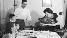 circa 1955:  A Thanksgiving turkey comes to the table watched by the family.  (Photo by Evans/Three Lions/Getty Images)