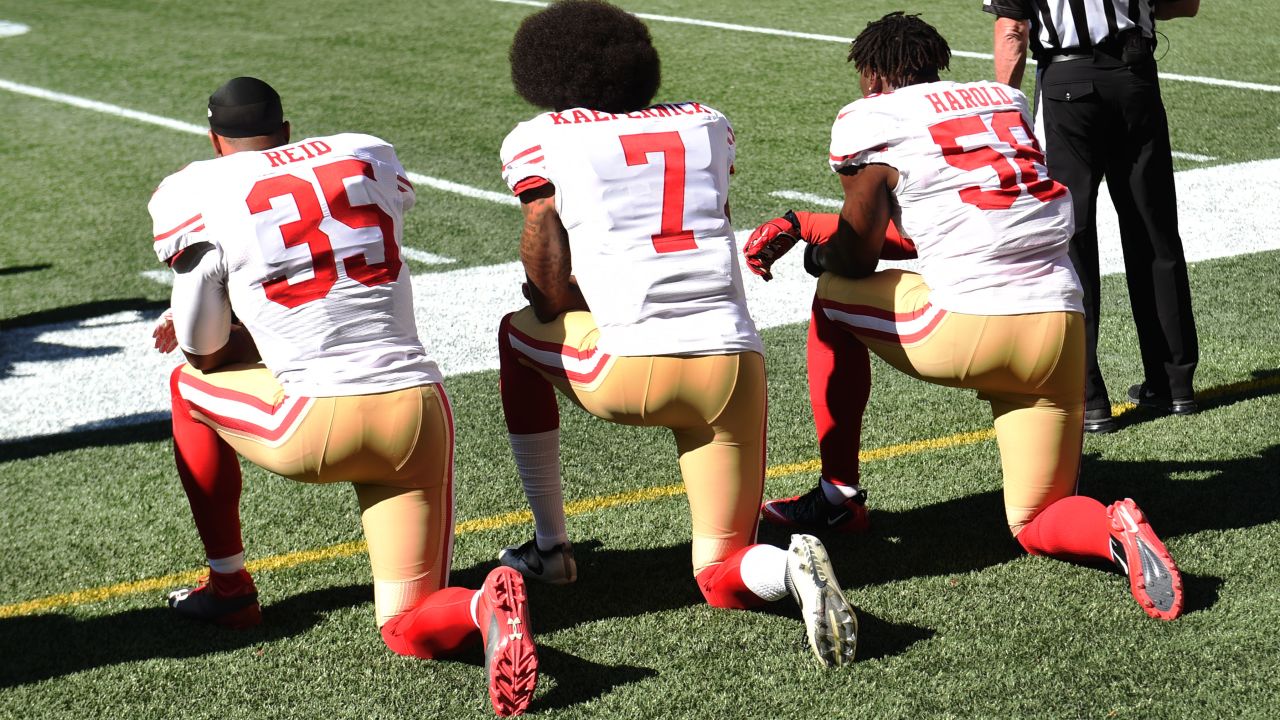 Colin Kaepernick and teammates kneel