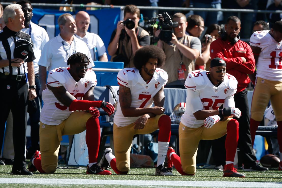 Colin Kaepernick #7 and members of the San Francisco 49ers kneel during the national anthem prior to the game against the Seattle Seahawks on September 25, 2016 in Seattle, Washington.