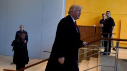 US President-elect  Donald Trump leaves after a meeting at the New York Times on November 22, 2016 in New York.
US President-elect Trump said Tuesday he has an open-mind about pulling out of world climate accords and admitted global warming may be in some way linked to human activity."I think there is some connectivity. Some, something. It depends on how much," he told a panel of New York Times journalists. 
 / AFP / TIMOTHY A. CLARY        (Photo credit should read TIMOTHY A. CLARY/AFP/Getty Images)