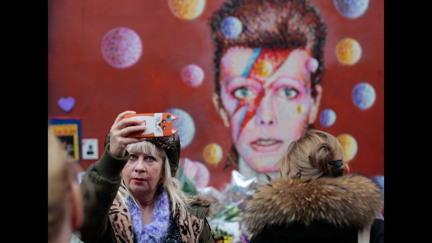 A woman takes a selfie in front of a David Bowie mural in London on Tuesday, January 12. <a href="http://www.cnn.com/2016/01/11/entertainment/david-bowie-thr-obit/index.html" target="_blank">The rock legend died</a> January 10 at the age of 69.