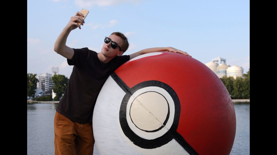 A young man takes a selfie Tuesday, July 26, by a sphere monument that had been painted into a giant "poke ball" in Yekaterinburg, Russia. The mobile game "Pokemon Go" <a href="http://money.cnn.com/2016/07/19/investing/pokemon-go-nintendo-shares/index.html" target="_blank">has been a sensation</a> for its company, Nintendo.